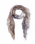 The Surfer Girls scarf by SUZI ROHER is a lightweight, rectangular accessory in neutral brown, beige, and gray tones with white script and a subtle mountain print, crafted in Italy from luxurious modal silk with frayed edges.