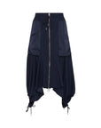 The HIGH Uphold skirt in navy blue features a cargo-inspired design with a front zipper, large side pockets, drawstring waist, and ties at the asymmetric hem for a gathered, draped effect.