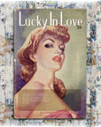The Suzi Roher "Lucky In Love" cover features a glamorous 1940s-style woman with red lips and wavy hair, alongside text noting 80,000,000 copies sold in a yellow box over a patterned background.