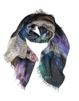 The "All Eyes On You" scarf by SUZI ROHER is a lightweight modal wool accessory with frayed edges, featuring a vibrant abstract design in blue, purple, green, black, touches of red, and hand-drawn notes inspired by monastery sketches.