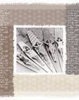 Five women in vintage swimsuits lie on longboards at the beach, smiling up at the camera. "Surfer Girls" by SUZI ROHER is framed with textured beige and brown squares and handwritten script along the borders.
