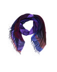 Introducing “Lily, AH!” by SUZI ROHER—a multicolored, digitally printed scarf showcasing vibrant shades of purple, blue, and red. Featuring a soft texture and fringed edges, this statement piece is displayed against a white background and is perfect for elevating any outfit.