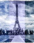 A crowd gathers at the Eiffel Tower 2.0, framed by clouds. The SUZI ROHER image—blue-tinted with vertical stripes and a textured filter—brings vintage charm to this iconic Parisian landmark.