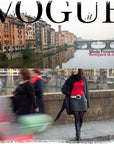 A Vogue Italia cover for SUZI ROHER's Moda Florentina: scenic Arno River buildings above, with a stylish Tuscan woman in red top and black jacket walking by Ponte Vecchio, blurred pedestrians in front.