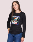 A woman with long brown hair models SUZI ROHER's The Catherine, a clean-cut 100% cotton black crew neck tee with colorful graphic art and "BIZZARE" on the front, posing with one hand in her pocket against a light background.