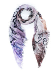 The SUZI ROHER Love Index Blush is a lightweight modal silk scarf with frayed edges, showcasing abstract patterns and bold black numbers, artfully styled in a loose loop on a white background.