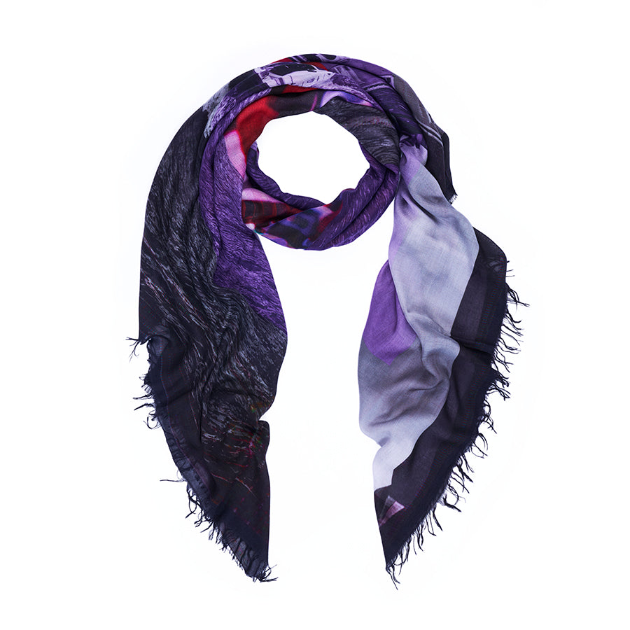 Introducing Tutti Matti by SUZI ROHER—a triangular scarf crafted from soft, lightweight fabric and finished with frayed edges. Showcasing a vibrant blend of purple, red, black, and white hues, this stylish accessory features digitally printed original artwork inspired by a Venice postcard, beautifully set against a crisp white background.