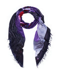 Introducing Tutti Matti by SUZI ROHER—a triangular scarf crafted from soft, lightweight fabric and finished with frayed edges. Showcasing a vibrant blend of purple, red, black, and white hues, this stylish accessory features digitally printed original artwork inspired by a Venice postcard, beautifully set against a crisp white background.