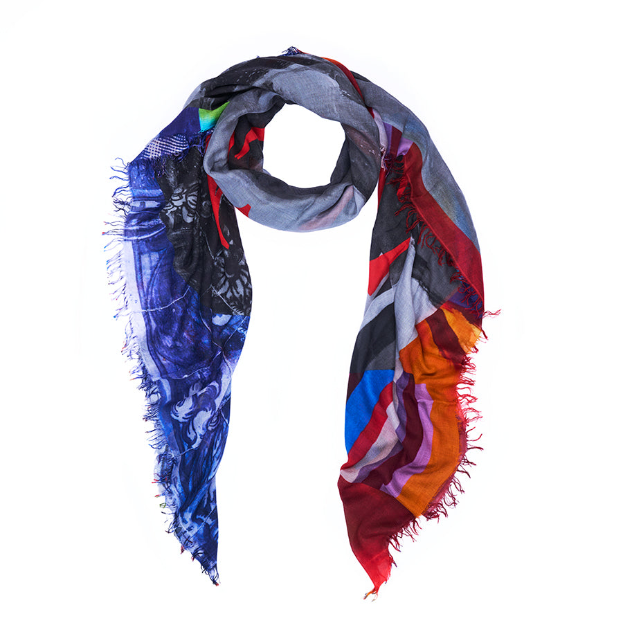 Introducing “Made Love” by SUZI ROHER—a vibrant scarf adorned with abstract patterns in blue, red, orange, gray, and black. Digitally printed from original artwork for stunning detail and finished with frayed edges, this accessory is displayed against a white background and perfectly captures SUZI ROHER’s signature flair for bold style.