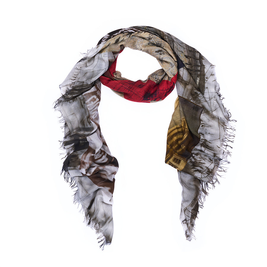 The SUZI ROHER “Number 6” scarf is a lightweight, rectangular accessory with frayed edges, showcasing an abstract design inspired by numerology art in shades of red, beige, brown, gold, and gray on a white background.
