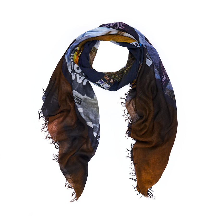 Introducing the James Bond scarf by SUZI ROHER—a lightweight, square accessory with frayed edges, digitally printed from original Bond film-inspired artwork in a striking abstract pattern of brown, blue, yellow, and black. Drape it loosely in a triangular shape for effortless style.
