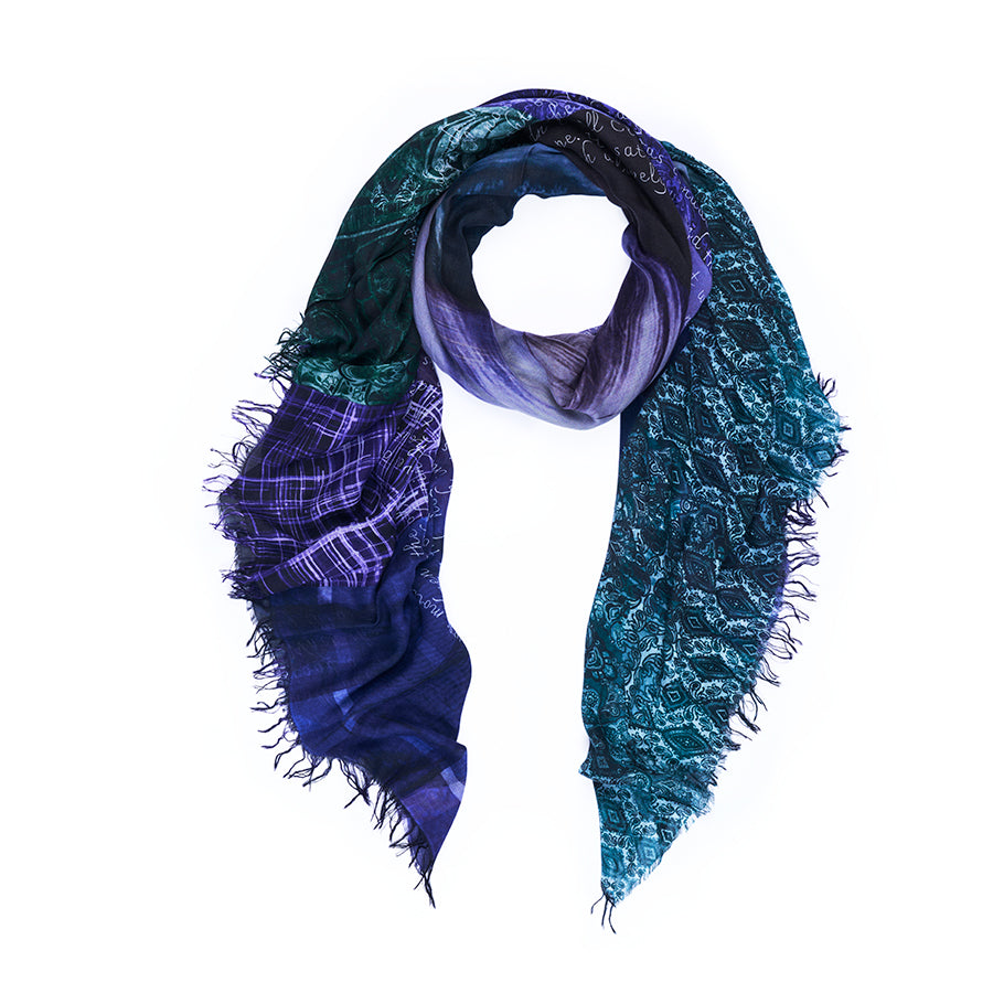 The Lady Chatterley scarf by SUZI ROHER features a blend of deep blue, purple, and green in mixed patterns, with frayed edges and a looped arrangement set against a white background. This distinctive piece showcases digitally printed original artwork for an artistic flair.