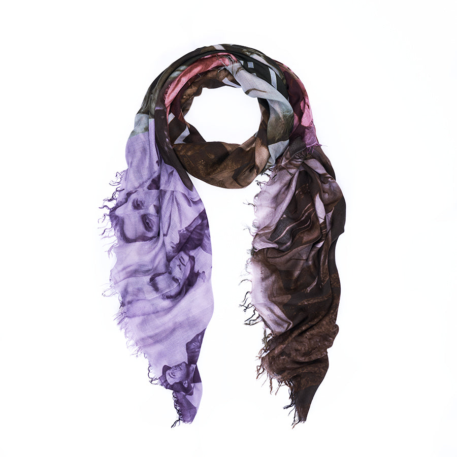 The SUZI ROHER “Films D’Amour” scarf is a lightweight piece, digitally printed with a purple and brown abstract pattern that includes faces and figures reminiscent of film stills, and is shown loosely draped in a loop on a white background.