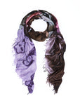 The SUZI ROHER “Films D’Amour” scarf is a lightweight piece, digitally printed with a purple and brown abstract pattern that includes faces and figures reminiscent of film stills, and is shown loosely draped in a loop on a white background.