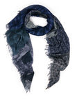 The SUZI ROHER "Wanna Hold Your Hand" scarf in blue and black brocade plaid with frayed edges showcases checkered and textured designs, displayed in a loose curve on a white background.