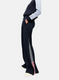 Black track pants with red and white stripe on a light gray background