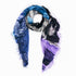 The SUZI ROHER Color of Love-Blues scarf is a lightweight, rectangular modal silk piece with frayed edges in blue, black, gray, and purple abstract patterns—ideal for showcasing your soul color. Shown on a white background.