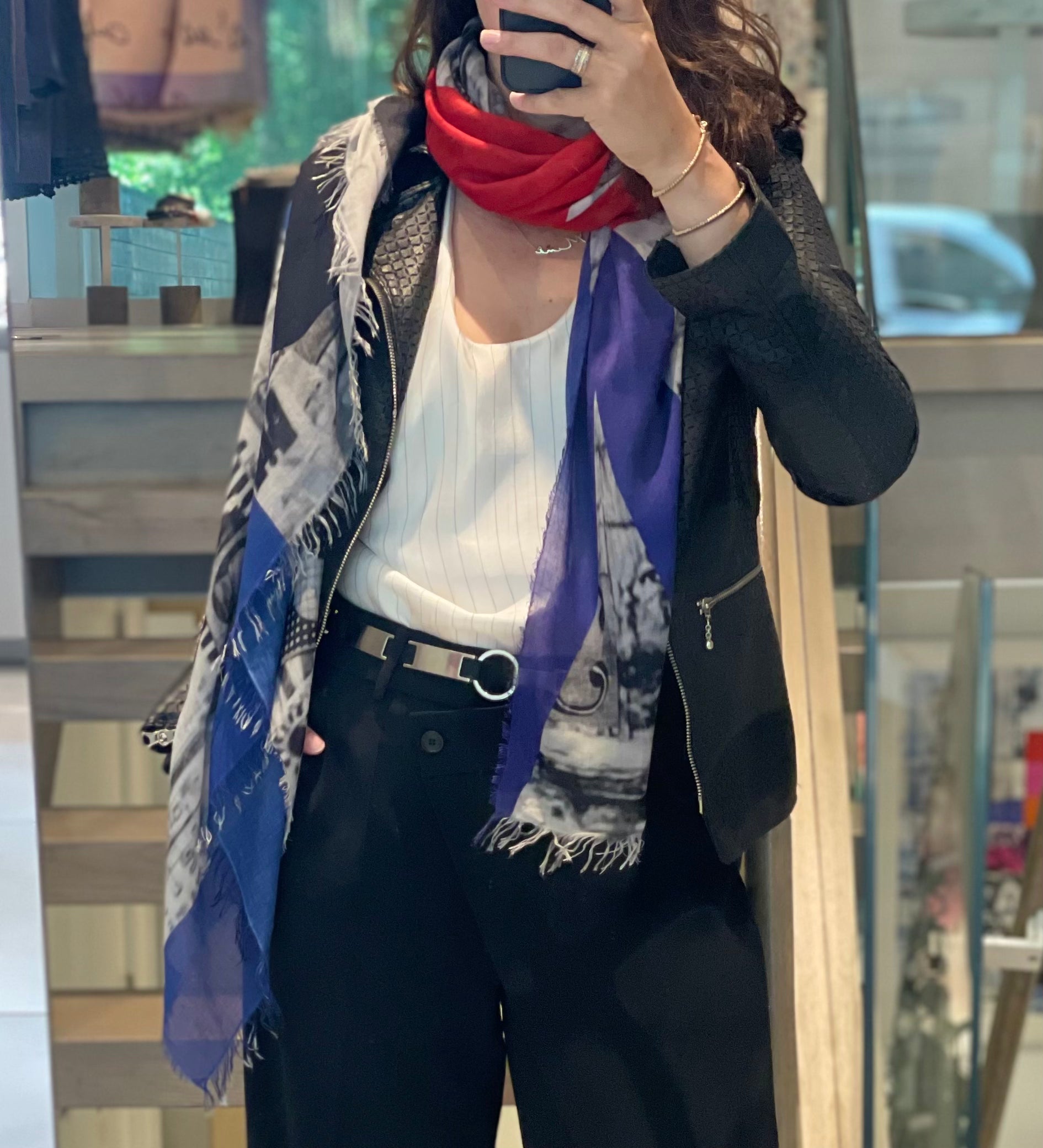 Person wearing a colorful scarf with a blurred indoor background