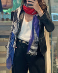 Person wearing a colorful scarf with a blurred indoor background