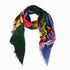 A vibrant rectangular SUZI ROHER Love Affair modal silk scarf with frayed edges and abstract patterns, loosely folded in a triangle on white. Made in Italy, it adds signature flair to any look.