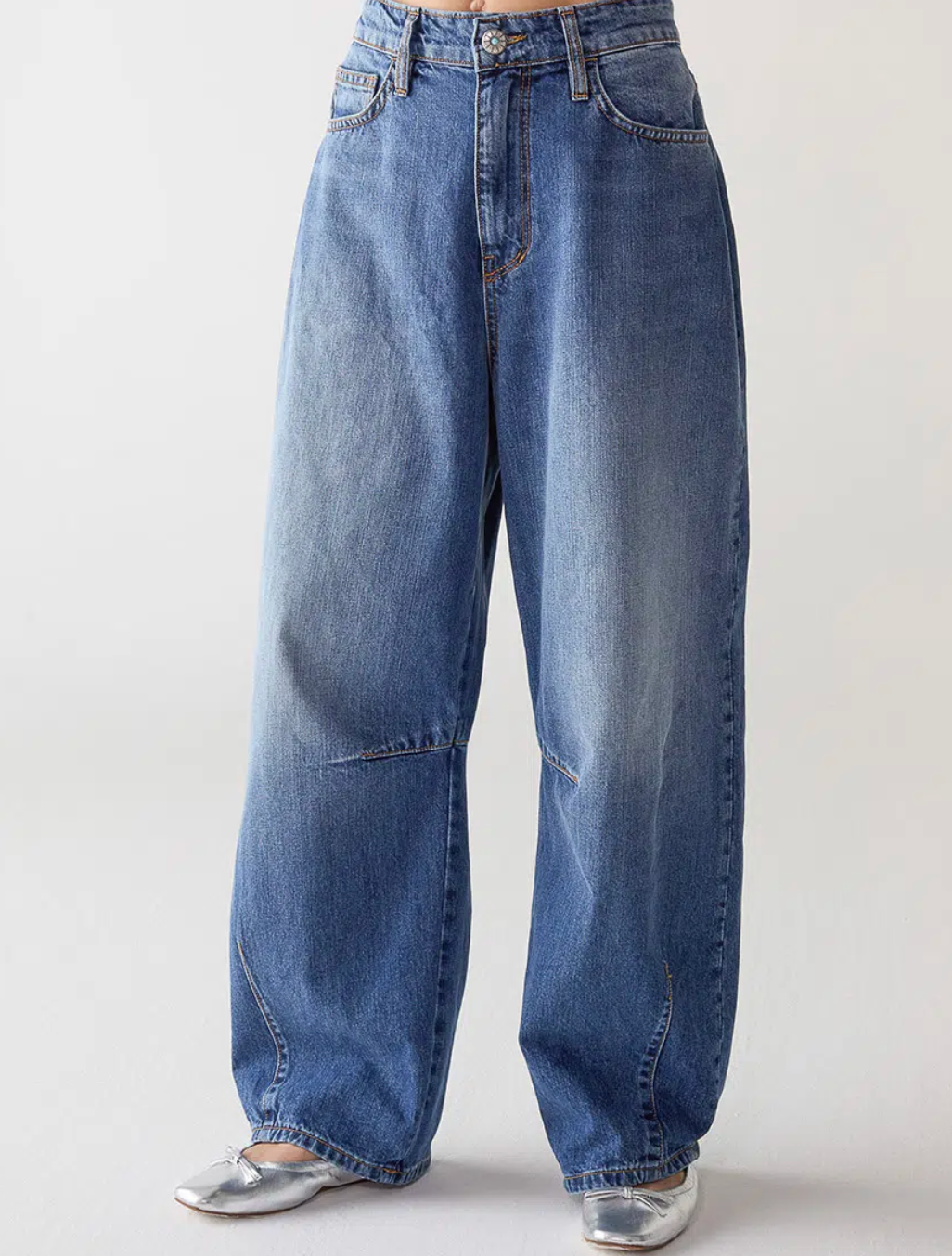 A person wears SHAFT Barrel Patriot Jeans—high-waisted, wide-leg blue denim with a relaxed fit and classic five-pocket style—paired with silver pointed-toe shoes against a plain light background.