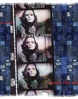 The SUZI ROHER "Rest Between Notes" luxury modal silk scarf, made in Italy, displays a filmstrip of a face with blue patchwork borders and the phrase "the rest between notes makes the music" in white and red.