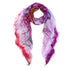 The SUZI ROHER "I Love Tea" modal silk scarf features frayed edges and a blend of pink, purple, red, and blue with faint black text. Loosely draped in a circle on a white background, it offers an elegant everyday look.
