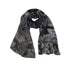The Barefoot in the Park scarf by SUZI ROHER is a lightweight modal silk accessory with brocade plaid, black and white dots, and floral sections on a 70 x 200 cm fabric, shown loosely coiled against a white background.