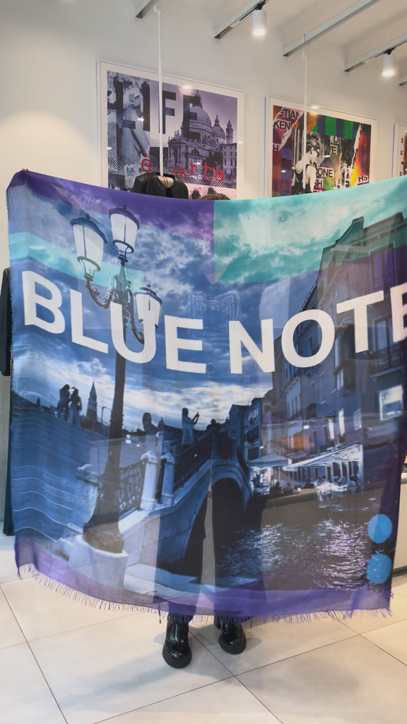 Video of a scarf being put on - Collage of a cityscape with a bridge and street lamp, featuring the text 'BLUE NOTE' on a colorful background.