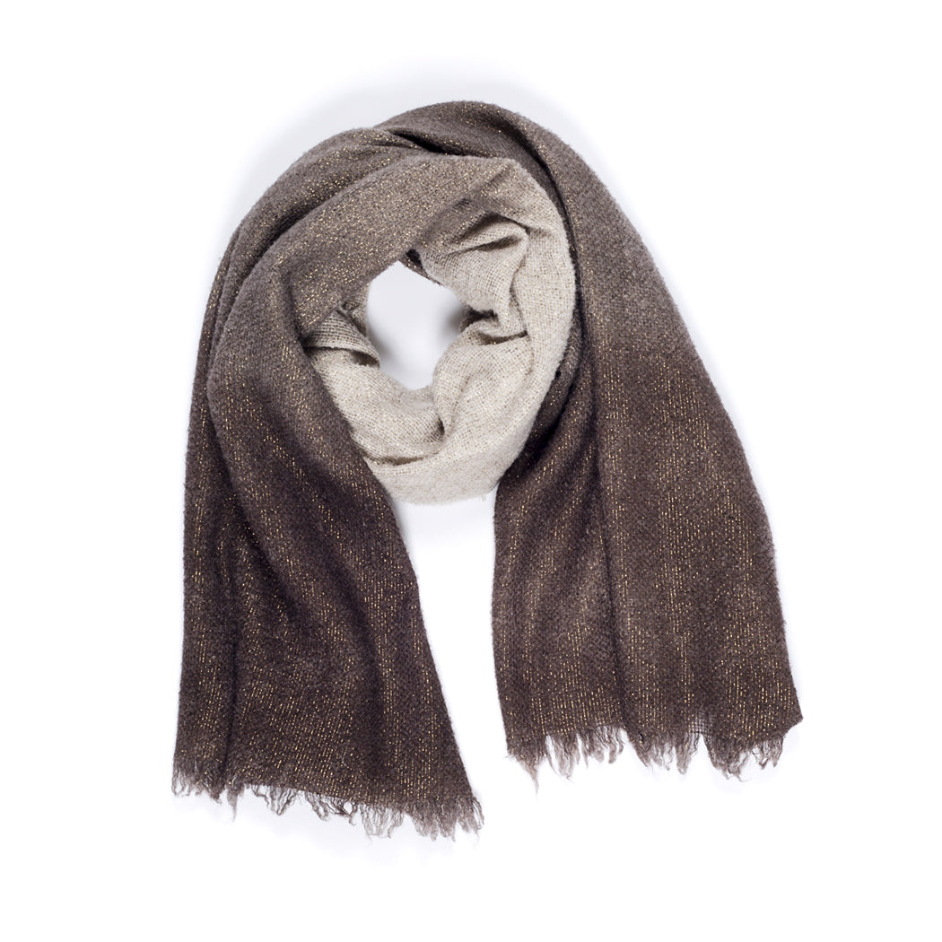 The SUZI ROHER Elena scarf features a cozy winter ombre, blending light beige to dark brown with subtle metallic threads and fringed edges. Warm and inviting, it's shown in a loose circle on a white background.