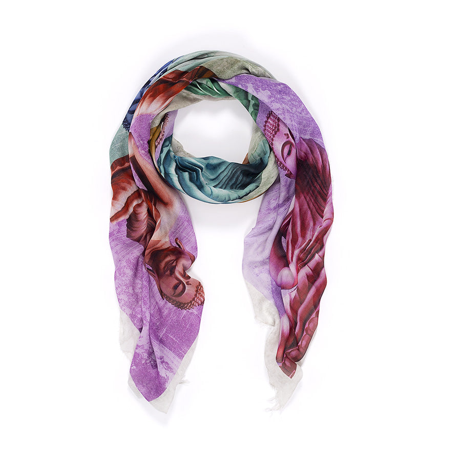 The Suzi Roher "Shar, Buddha - colors" silk scarf displays vibrant digital patterns in purple, green, red, and beige, artfully looped with draped ends against a white background.