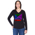 A woman stands confidently with one hand on her hip, looking at the camera. She wears The Victoria long-sleeve shirt by SUZI ROHER, featuring a colorful geometric “LOVE” and “1984” design, paired with a stylish scarf.