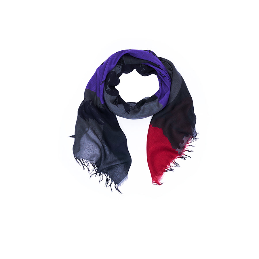 The SUZI ROHER “Lily, Lucy” scarf, inspired by Lucille Ball artwork, features color blocks of purple, gray, black, and red with frayed edges. Arranged in a loose circle on a white background, the vibrant design captures the playful charm of I Love Lucy art.