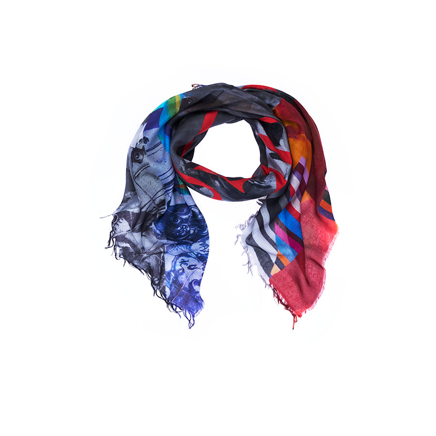 The “Lily, Made Love” scarf by SUZI ROHER showcases a vibrant design of diagonal stripes in red, blue, orange, and gray tones with abstract patterns inspired by original artwork. Digitally printed and finished with frayed edges, this eye-catching accessory is beautifully displayed on a white background.