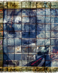 A grid of weathered, square tiles adorned with colorful graffiti and scribbles reveals the faint suggestion of a face behind them. In the corner, a small red label features the words “Against All Odds” by SUZI ROHER.