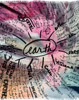 Featuring “Earth” by SUZI ROHER, this vibrant abstract mind map centers on our planet, with earth depicted at the core and surrounded by handwritten words and concepts such as trees, animals, soil, humans, nature, ocean clarity, and plants extending outward. Subtle water-inspired highlights amplify the vivid visuals and emphasize the deep interconnectedness of life on Earth.