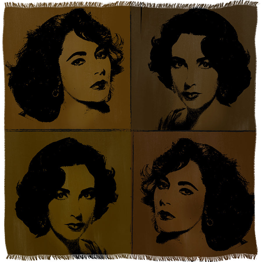 The “Elizabeth Brown” woven textile by SUZI ROHER features four pop art-style portraits of the same woman with dark curly hair, arranged in a 2x2 grid, each rendered in different brown and gold tones. The textile is finished with fringed edges.