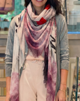 Close-up of a soft fabric with frayed edges in shades of pink and blush.