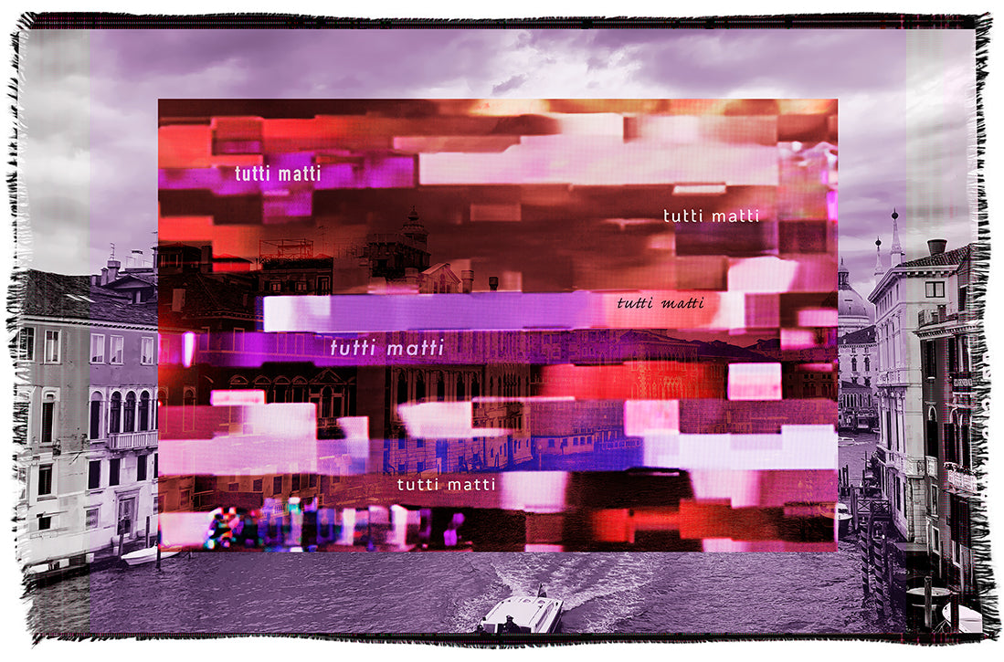 A black-and-white Venice canal scene is overlaid with a vivid, pixelated digital collage in red and pink tones featuring the words “tutti matti” throughout the colorful design. The artwork, titled Lily, Tutti Matti, is by SUZI ROHER.