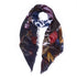 The "What's Next" square scarf by SUZI ROHER features frayed edges, a dark floral pattern, scattered white text, and modern editorial flair—artfully arranged to make a stylish statement.