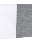 The Farah Silver by SUZI ROHER is a rectangular two-tone cotton modal viscose wrap with vertical stripes: one side white with gray borders, the other solid gray. It features a slightly crinkled texture and fringed edges.