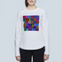A woman wears The Catherine by SUZI ROHER, a white long-sleeve shirt with bold, colorful motivational words—INSPIRATION, HONESTY, COURAGE, PASSION, BREATHE—and a red heart on the front.
