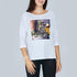 A woman smiles in front of a gray background, wearing The Bailey, a luxurious white long-sleeve shirt by SUZI ROHER featuring a graphic print and black text: "It’s great! I love the coffee with charm and sugar! It’s great! Not love!.