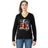 A woman with light skin and brown hair in a ponytail wears The Violet, a black 100% cotton long sleeve shirt by SUZI ROHER featuring a colorful Daily Planet graphic, paired with blue jeans, standing facing forward against a white background.