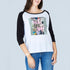 A woman stands against a light gray background wearing SUZI ROHER's The Bailey, a 100% cotton boxy cut tee featuring a colorful abstract graphic and "There is Hope" text on the front, paired with blue jeans.